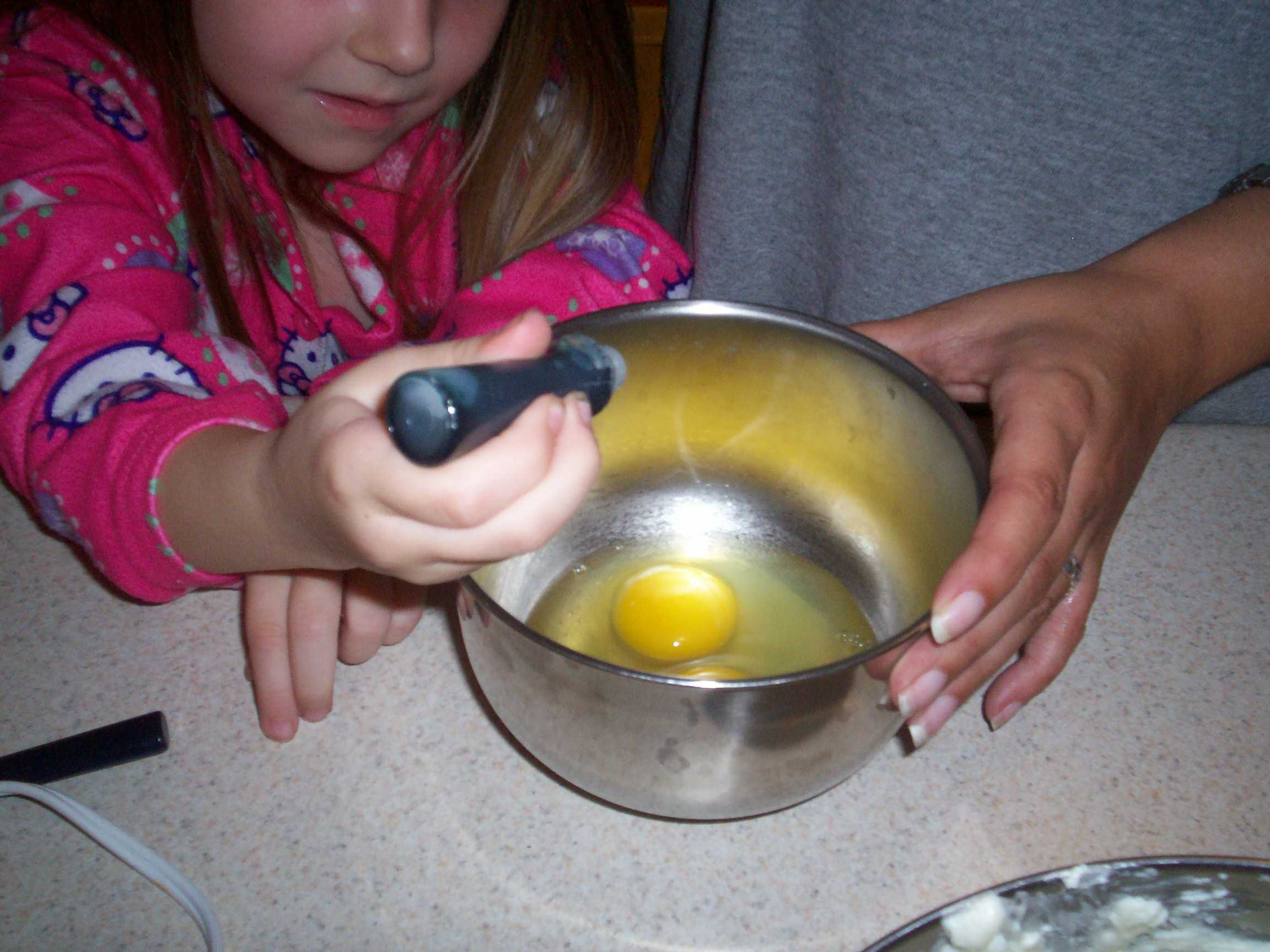 drops of green coloring added to bowl of eggs