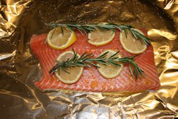 salmon-on-foil Placing the sprigs on the lemon slices helps keep the rosemary from becoming overpowering.